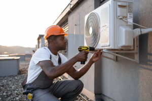 rsz 1man kneeling with screwdriver near air conditioner 2023 12 21 22 00 43 utc 1